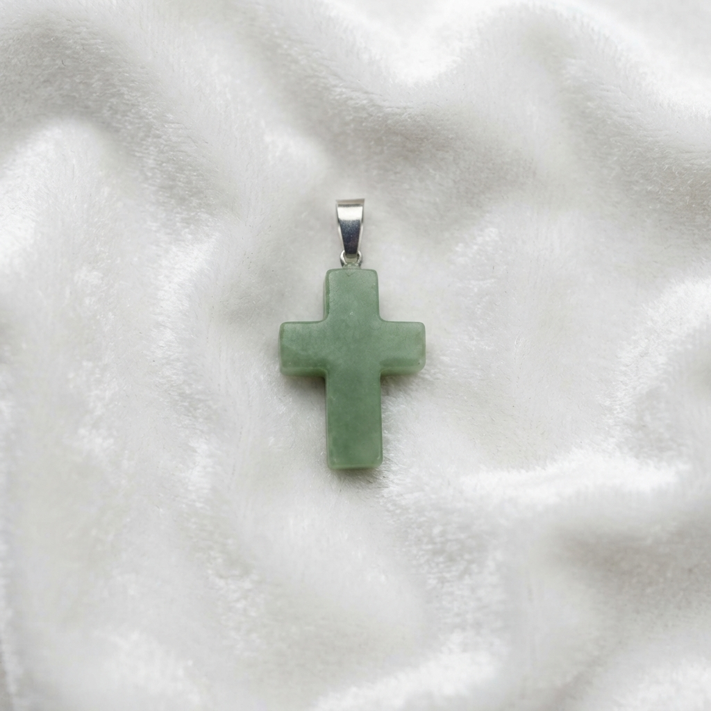 Green Aventurine Christian cross necklace shown against a light gray top