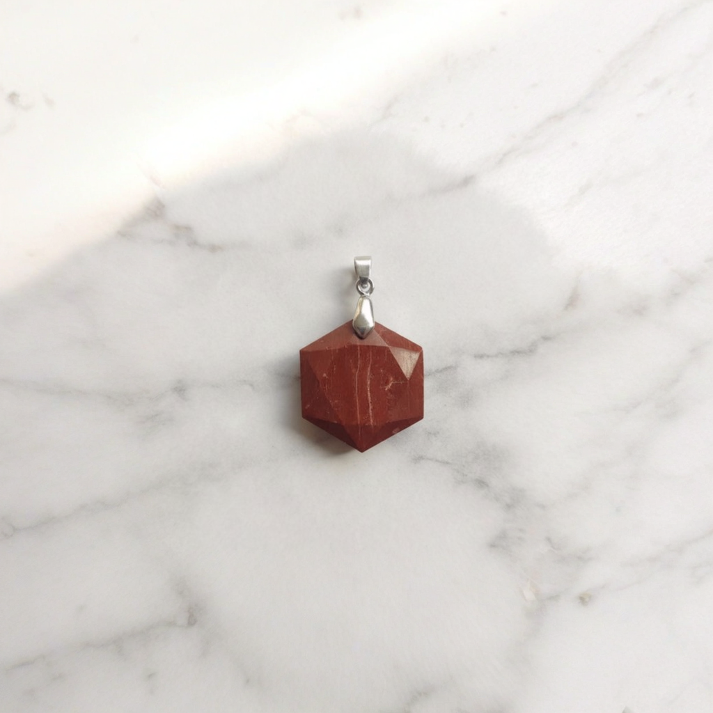 Red stone hexagon pendant with silver-tone bail and included necklace chain