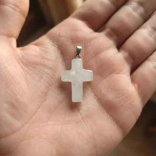 Clear quartz cross pendant necklace worn on a person with a silver-tone chain - 2nd View
