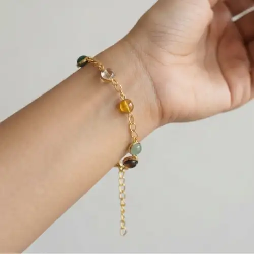 Gold Tone Bracelet With Multicolor Gemstone Beads Shown In Hand