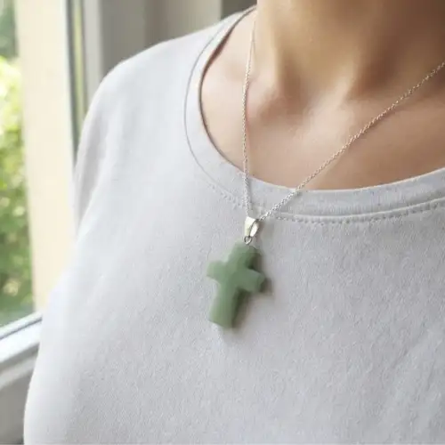 Green Aventurine cross pendant necklace worn on a person with a silver-tone chain