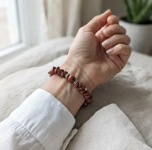 Red Jasper Crystal Chip Beaded Bracelet with Polished Center Bead Displayed on White Jewelry Stand – Natural Stone Bracelet | OneTrend India - 2nd View