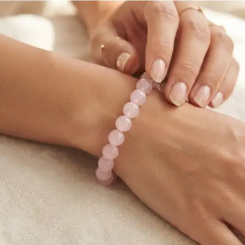 Rose Quartz Bracelet With Light Pink Round Beads Worn On Wrist